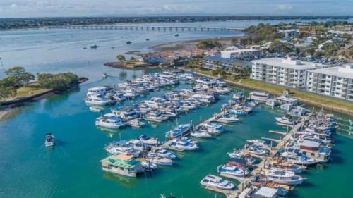 an aerial view of a marina with boats in the water at Family Holiday Home At Sandstone Point in Sandstone Point