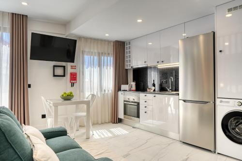 a kitchen and living room with a couch and a table at Beco Santa Emilia 4Q, a Home in Madeira in Funchal