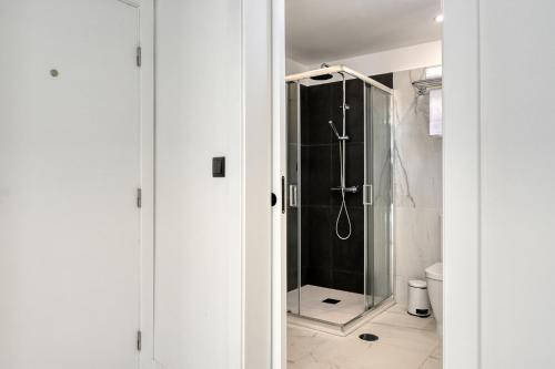 a shower with a glass door in a bathroom at Beco Santa Emilia 4Q, a Home in Madeira in Funchal