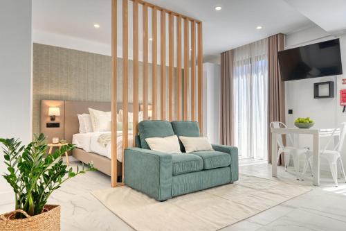 a bedroom with a bed and a blue chair in front of a bedroom at Beco Santa Emilia 4Q, a Home in Madeira in Funchal
