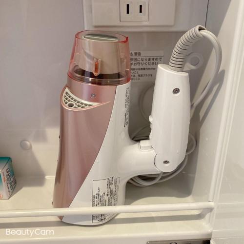 a kitchen appliance sitting inside of a refrigerator at ALL TRUST2馆临近心斋桥道頓堀难波直达梅田关西机场Usj全新独栋别墅四个卧室可住8人超大空间3卫2浴厨房设施齐全电视冰箱洗衣机空调配置齐全免费停车4分钟步行至今宫站 in Osaka