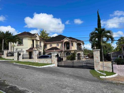 a house with a wrought iron gate on a street at Mandeville Vacation Home in Mandeville