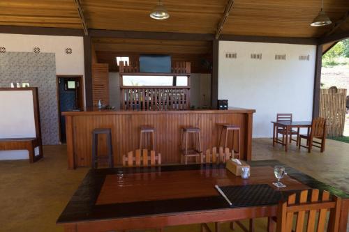 a bar in a room with a table and chairs at K2 Lembeh Dive Resort in Bitung