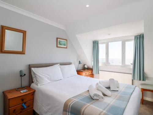 a bedroom with a bed with two towels on it at Lookout in Weymouth