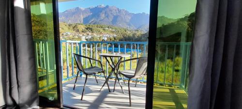 a view of a balcony with a table and chairs at Wind Valley Farmstay in Kampong Kundassan