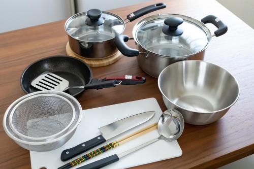 a kitchen counter with cooking utensils and a strainer at Oyado Nishishichijo in Kyoto