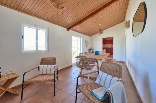 a living room with a table and chairs at Comporta Sandy Villa, By TimeCooler in Comporta
