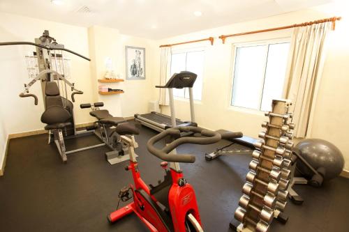 a gym with bikes and weights in a room at Ixchel Beach Hotel in Isla Mujeres