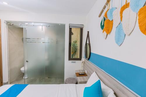 a bedroom with a shower and a bed with blue at TÒ VÒ Hostel 2 - Huế in Hue