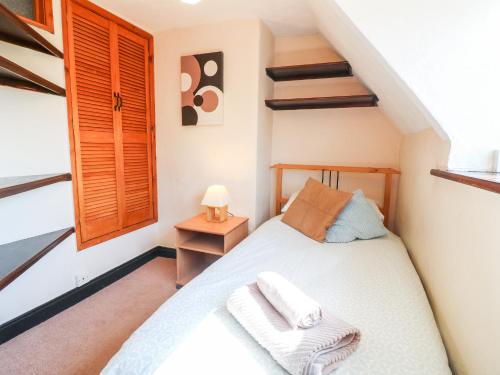 a bedroom with a bed with two towels on it at Manor View in Oakham