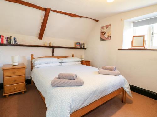 a bedroom with a bed with two towels on it at Manor View in Oakham