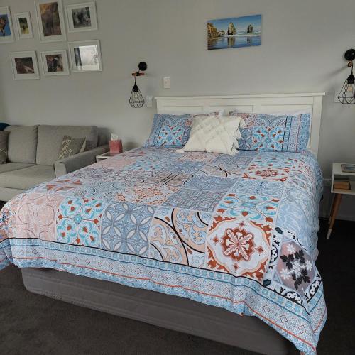 a bedroom with a bed and a couch at Welbourn Accommodation in New Plymouth