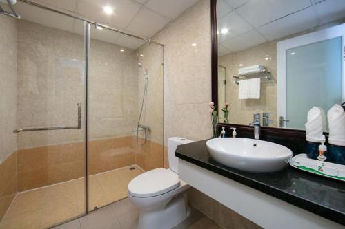 a bathroom with a toilet and a sink and a shower at Hanoi 20 Hotel HN - by BAY LUXURY in Hanoi