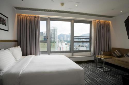 a hotel room with a bed and a large window at Hotel One Eighteen in Hong Kong