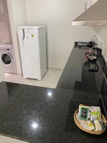 a kitchen with a counter top with a refrigerator at Acogedor dpto! Zona Conmebol 505 in La Mercedes
