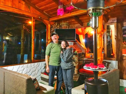a man and a woman standing in a room at Hospedaje Vertientes del Imbabura in Otavalo