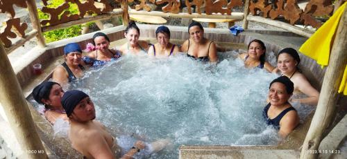 a group of people in a pool of water at Ricky's House in Baños
