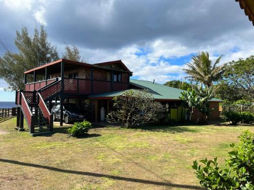 a house with a staircase in front of it at Cabañas Christophe in Hanga Roa