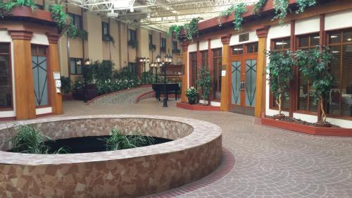 a large building with a courtyard with a fountain at Canad Inns Destination Centre Fort Garry in Winnipeg
