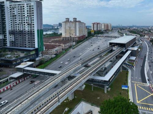 a bridge over a highway in a city with buildings at One Room Studio with WiFi and MRT in Seri Kembangan