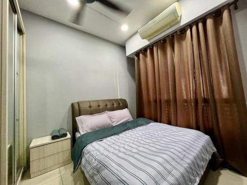 a bedroom with a bed with a brown curtain at One Room Studio with WiFi and MRT in Seri Kembangan