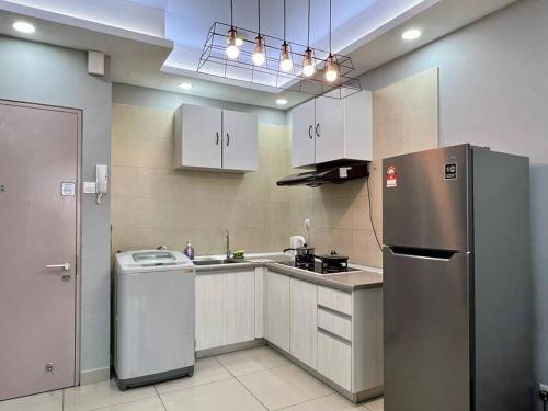 a kitchen with a stainless steel refrigerator and a sink at One Room Studio with WiFi and MRT in Seri Kembangan