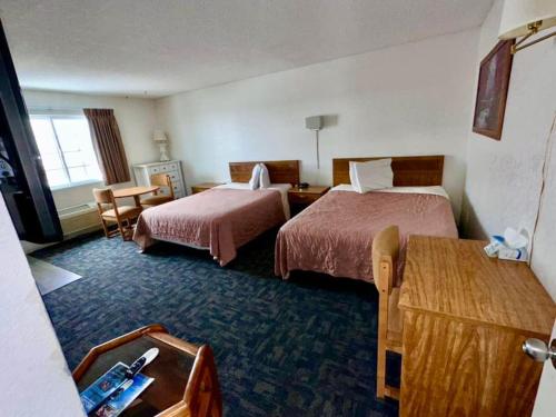 Postel nebo postele na pokoji v ubytování Sundown Lodge