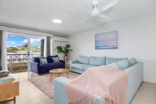 a living room with a couch and a table at Luna Blu - Private Apartment Yeppoon in Yeppoon