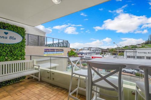 a balcony with a table and chairs and a view at Luna Blu - Private Apartment Yeppoon in Yeppoon
