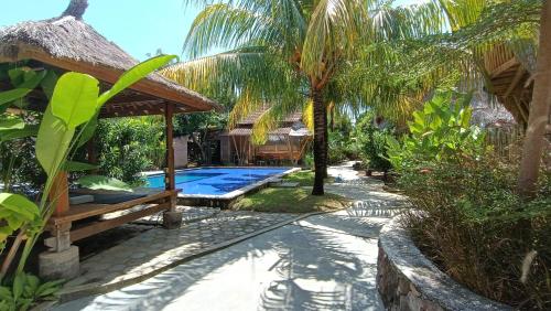 a villa with a swimming pool and a resort at Hawera Village in Kuta Lombok