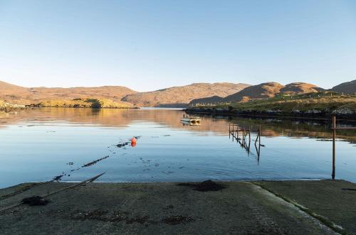 a body of water with two boats in it at Tigh Chailein in Tarbert