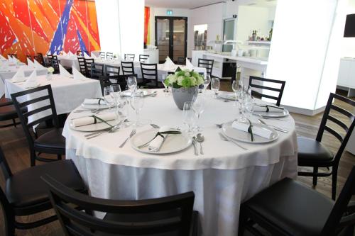 a dining room with a table with white table cloth at M Hotel in Ljubljana