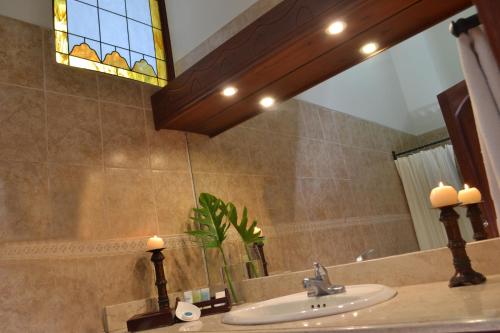 a bathroom with a sink and a mirror at Hotel Dario Granada in Granada