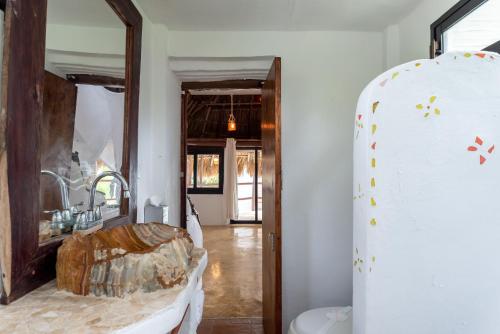 a bathroom with a sink and a mirror at Casa Aakbal - Luxury Beach Front Villa in Tulum