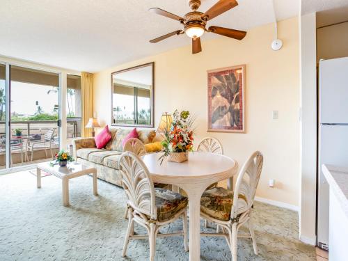 a living room with a table and a couch at Maui Banyan in Wailea