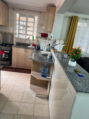 a kitchen with a large counter top in a room at B’s homely in Ruiru