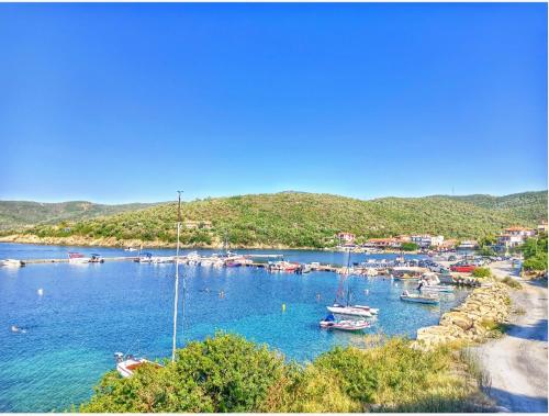 a group of boats in a harbor on the water at Doras House in village Άνετο Διαμέρισμα υπέροχη θέα in Pyrgadikia