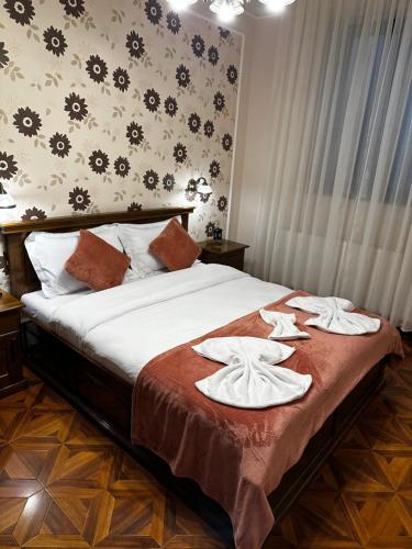 a bedroom with a bed with towels on it at Sylt in Sibiu