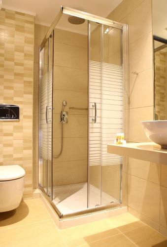 a shower in a bathroom with a toilet and a sink at Golden Beach in Hersonissos