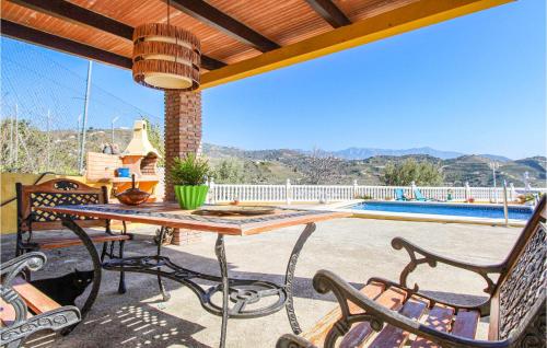 a patio with a table and chairs and a pool at Villa Pastor, Torrox, Málaga in Torrox