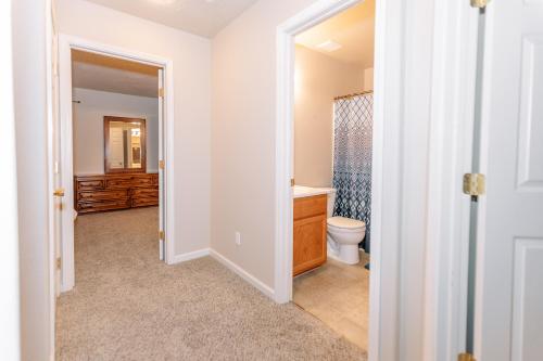 a bathroom with a toilet and a sink and a shower at Relax in Post Falls with No Noise Pollution in Post Falls