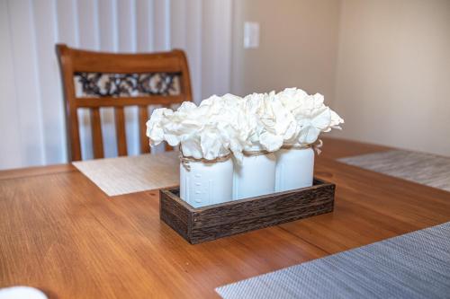 two white vases with white flowers on a table at Relax in Post Falls with No Noise Pollution in Post Falls