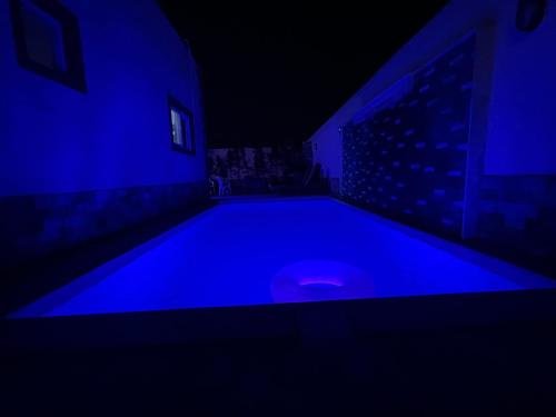 an empty swimming pool in a dark room with blue lights at Nubian Villa with Private Pool in Naj‘ al Aḩwāl