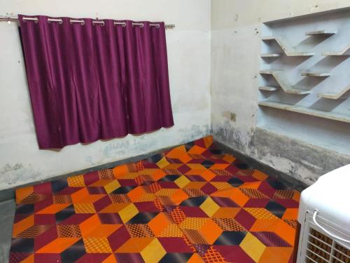 a room with a colorful tiled floor with a curtain at Prabhu Raj villa HomeStay in Varanasi