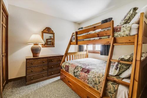 a bedroom with two bunk beds and a mirror at Sunrise Timberline G2 in Killington