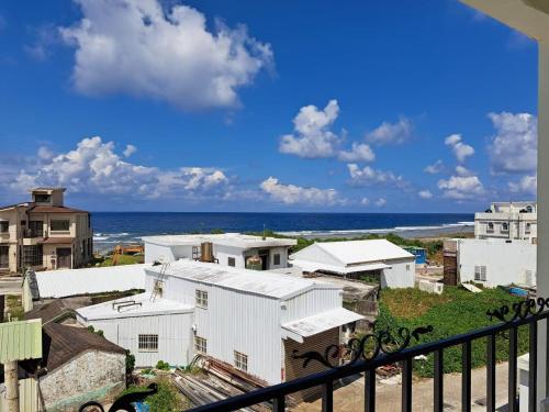 a balcony with a view of the ocean and buildings at Chi Mei Homestay in Green Island