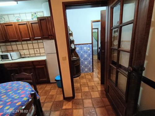 a kitchen with a door open to a kitchen with a counter at Apartamento Praia da Torreira in Torreira