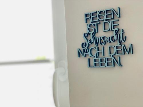 a door with a sign that reads reason first die samuraiishiishi demon hen at FeWo MEERESBRISE - Familie- Hunde - Strandnah - Garten-Seeblick - Sauna & Wellness in Sierksdorf