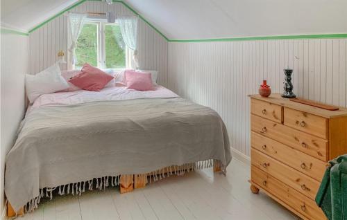 a bedroom with a bed and a window and a dresser at Pet Friendly Home In Boxholm With Kitchen in Blåvik