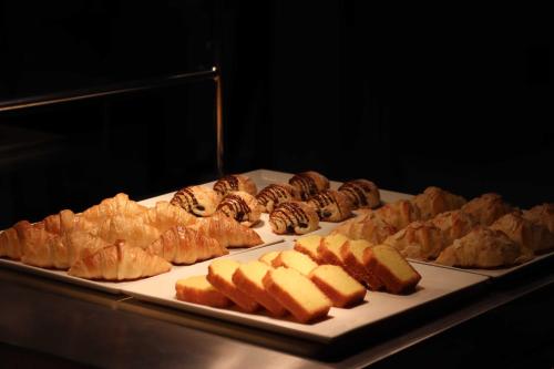 a tray of different types of pastries on a table at Foshan Marriott Hotel in Foshan
